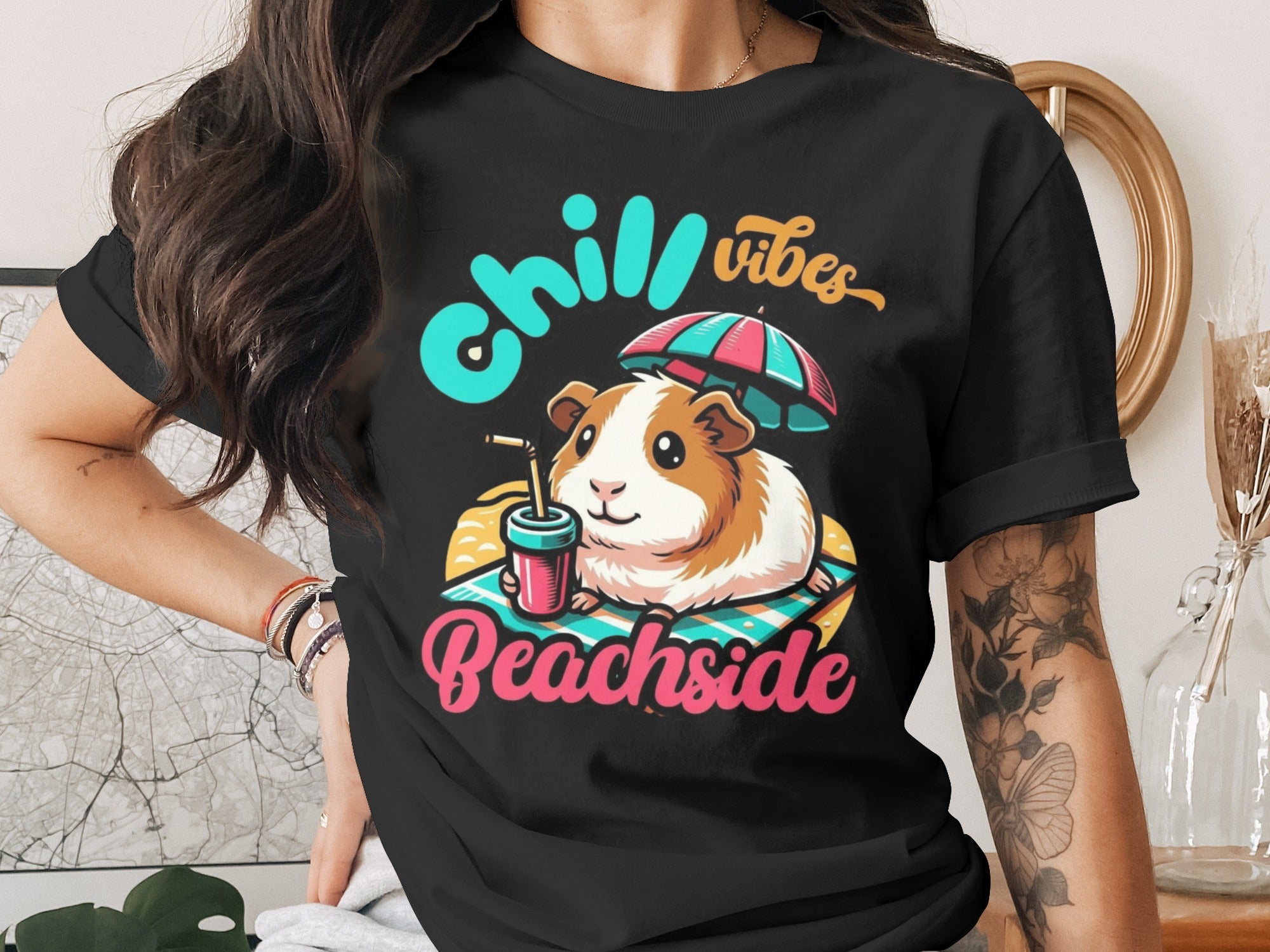 Black t-shirt with "Chill Vibes Beachside" text and a guinea pig under an umbrella.