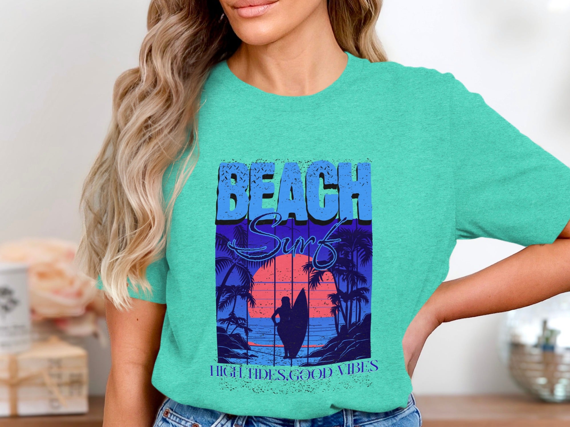 Teal t-shirt with "Beach Surf" text and a sunset surf scene.