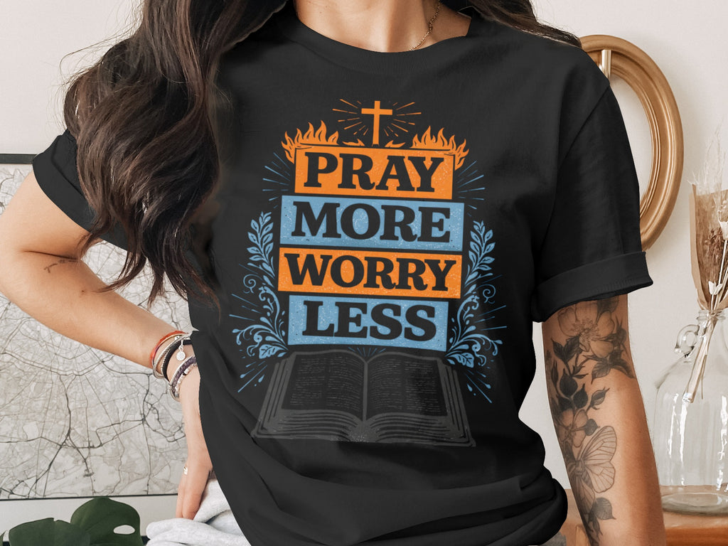 Black t-shirt with "PRAY MORE WORRY LESS" and religious cross graphic.